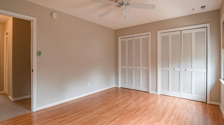 White bifold closet doors set in a light blue wall in closeup