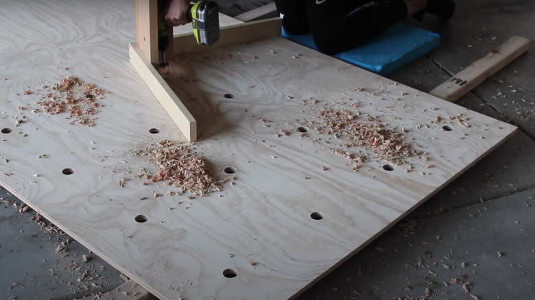 Someone creating a pegboard