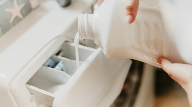 Pouring softener into laundry machine