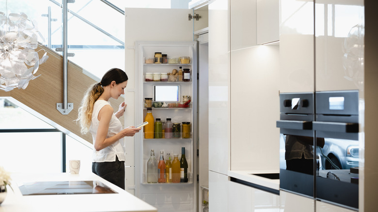 Woman looking in a fridge