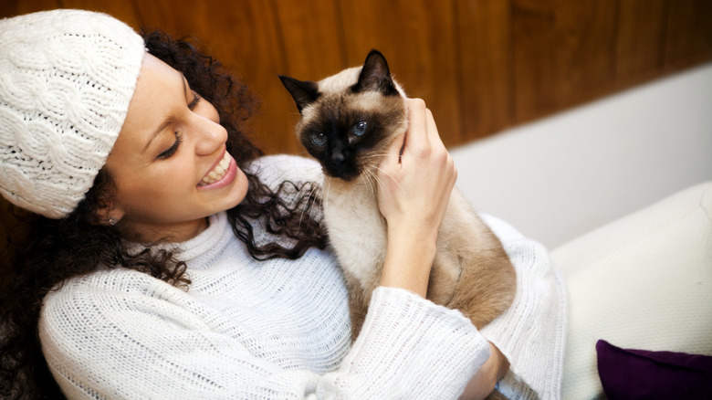 Woman cuddling cat