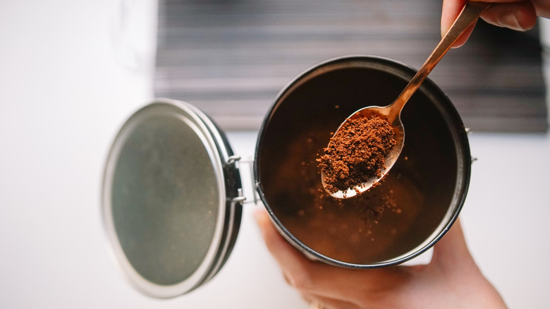 spoon scooping coffee grounds