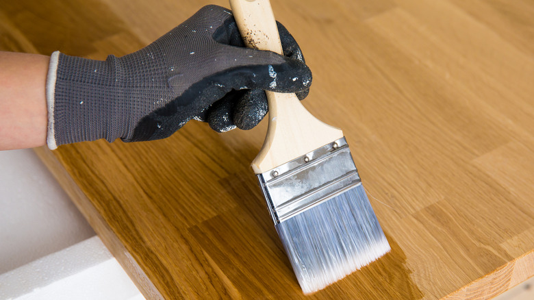 Person varnishing countertop