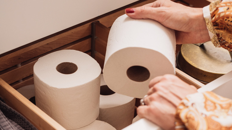 Person organizing toilet paper 