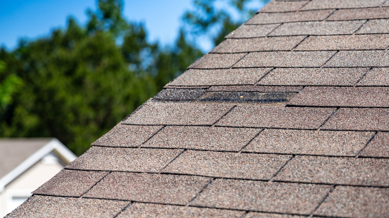 A roof with missing shingles