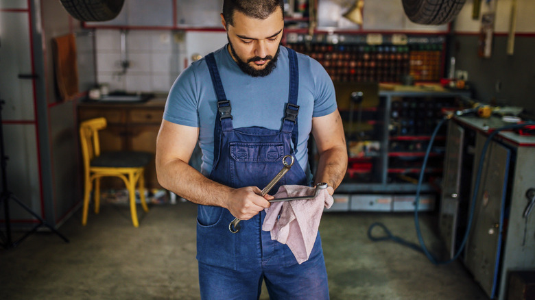 man cleaning tools