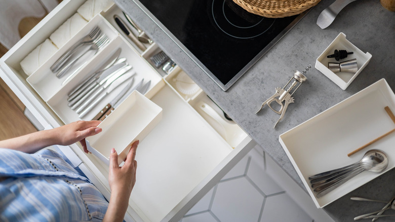 woman setting up drawer organizers