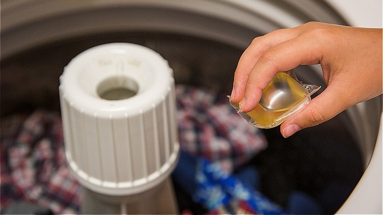 Putting laundry pod in washer