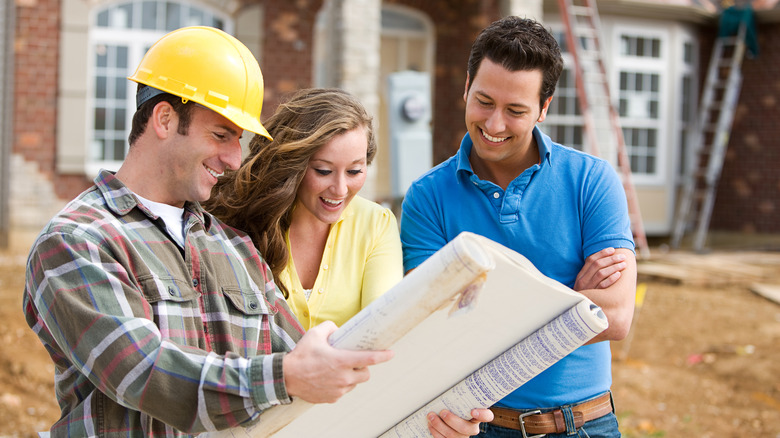 Couple discussing with builder