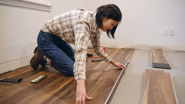 Woman laying wooden flooring