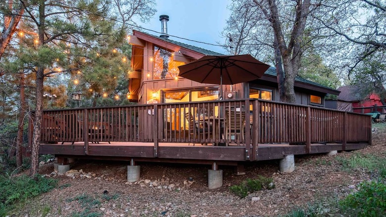 Brown cabin with deck and lights 