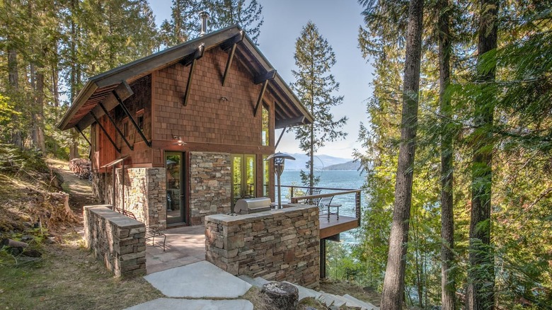 brown cabin overlooking lake