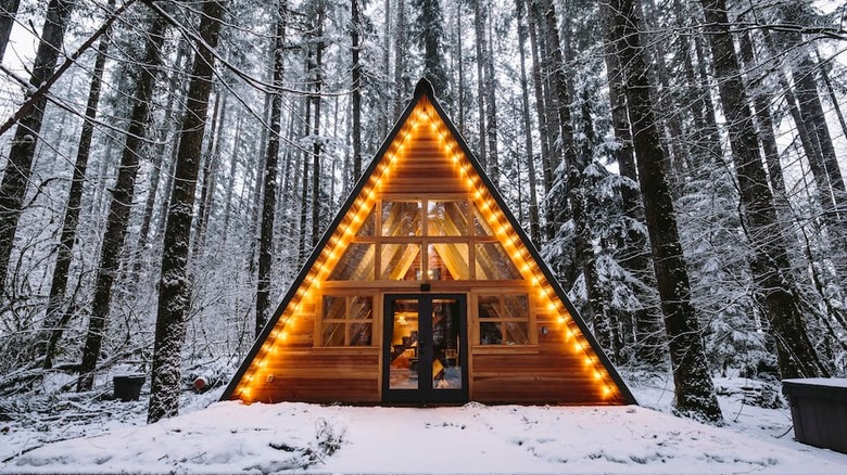 A-Frame cabin with lights in snow