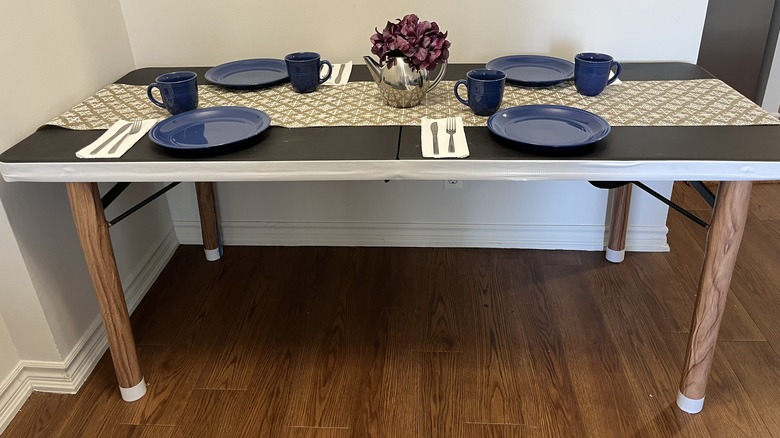 Black table set with blue dishes