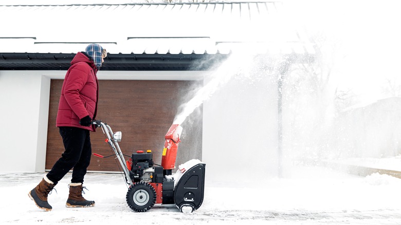 person using snow blower