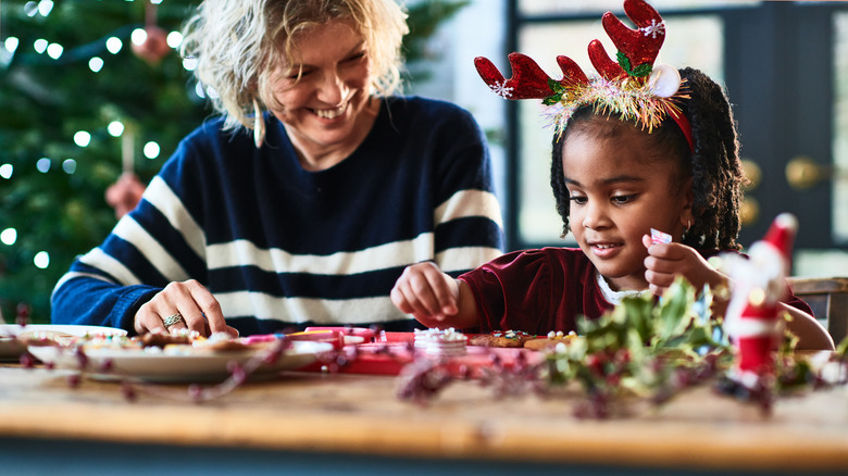 Woman and child making homemade Christmas decorations