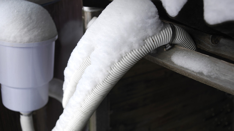 Frozen water pipes covered in snow and ice.