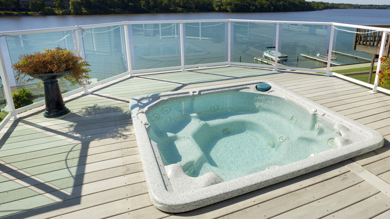 elevated deck with a hot tub