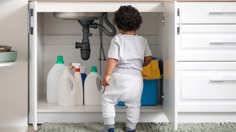 kid looking at cleaning products