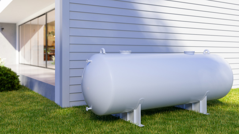 Propane tank by house yard