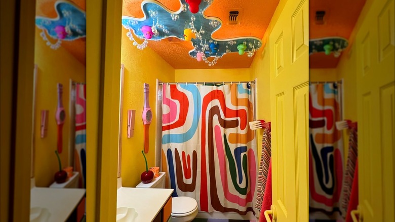 Maximalist surrealist playhouse style bathroom with handcrafted rubber ducky pond chandelier