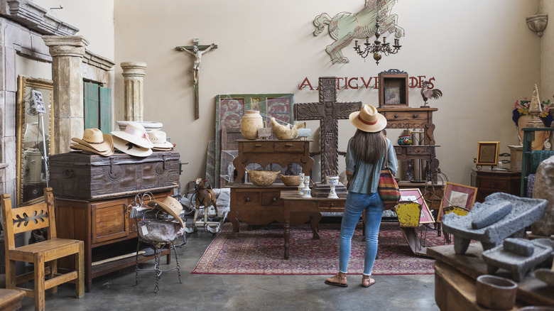 A woman shops for antique furniture