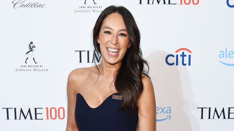 Joanna Gaines smiling in a blue dress at event