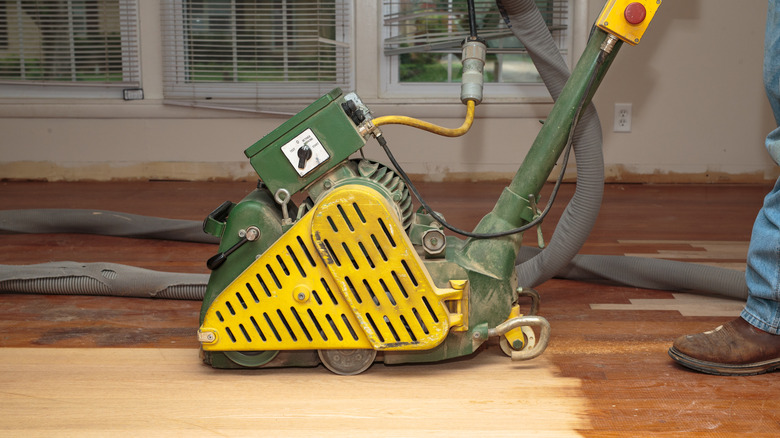 person and machine removing floor finish