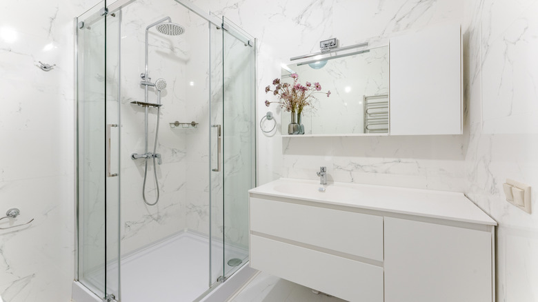 A minimalist bathroom with white and silver details