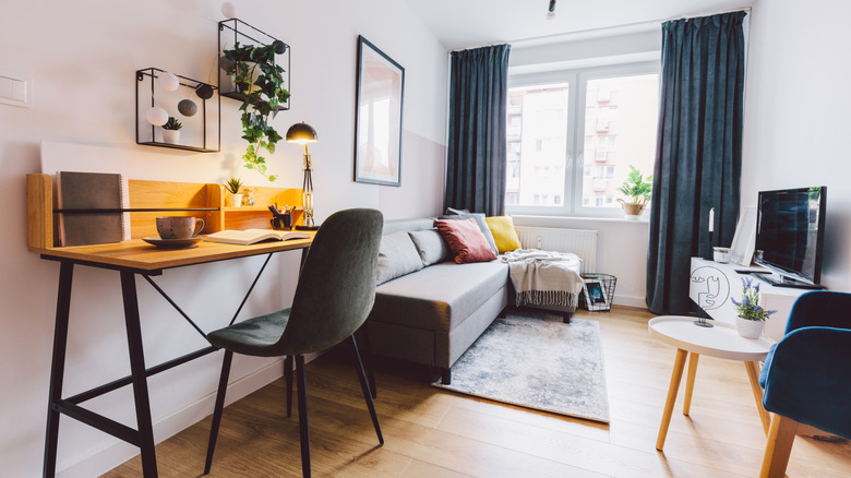 A small crowded living room features a lot of furniture