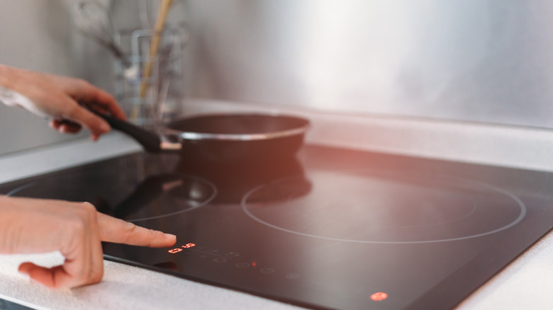 person cooking on induction stove