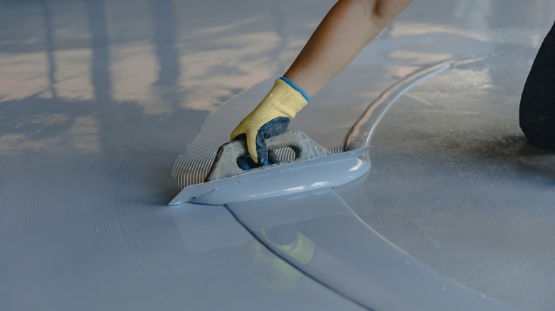 spreading epoxy resin on garage floor