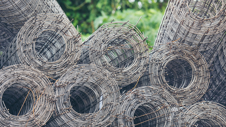 Numerous chicken wire fence rolls in the yard