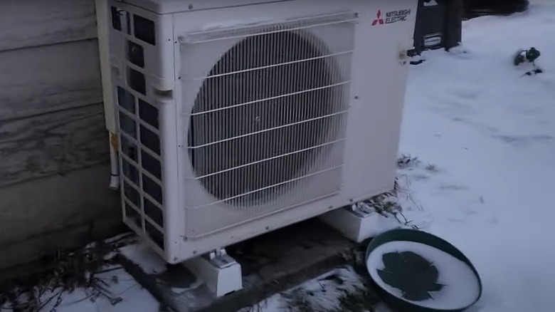 Mini-split system condenser outdoors in winter