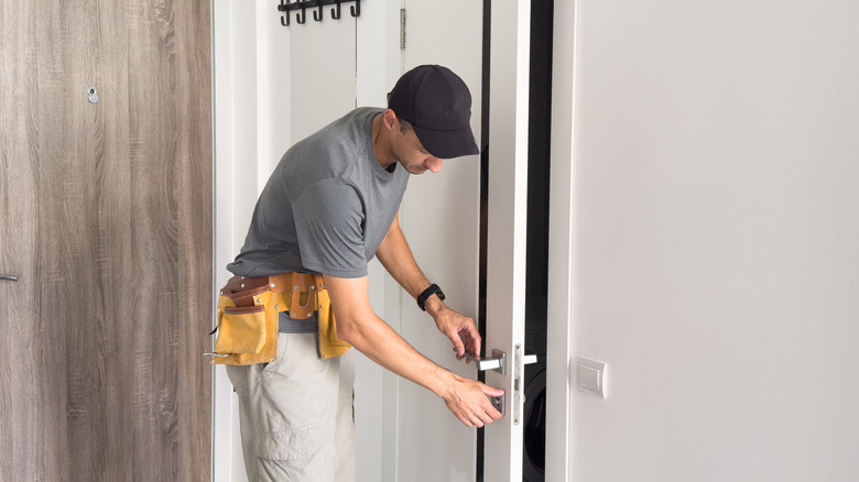 A person installs a new door