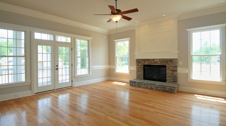 An unfurnished living room with a fireplace and shiny wood floors