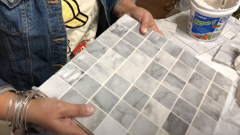 Woman holding a mosaic placemat