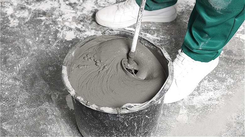 Person mixing concrete indoors