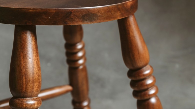 Close-up of dark stained turned leg stool