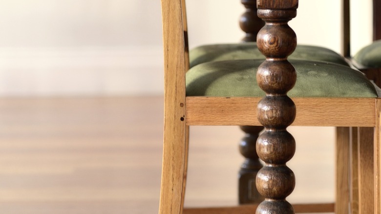 Close-up of wood turned table leg next to dining chair