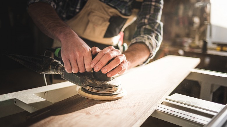 Person sanding lumber