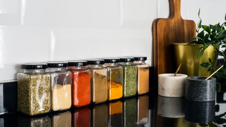 Black counter with spice jars on it