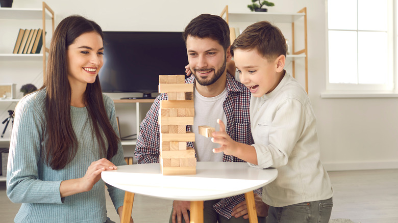 A family playing with tumbling blocks