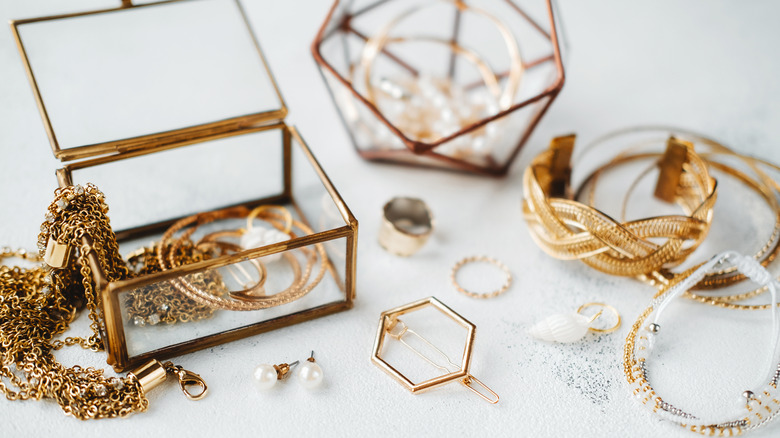 Pieces of jewelry strewn across a white background.