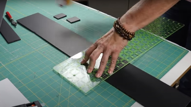 Person cutting a foam board