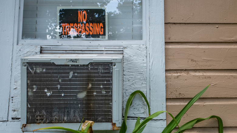 window ac with no trespassing sign