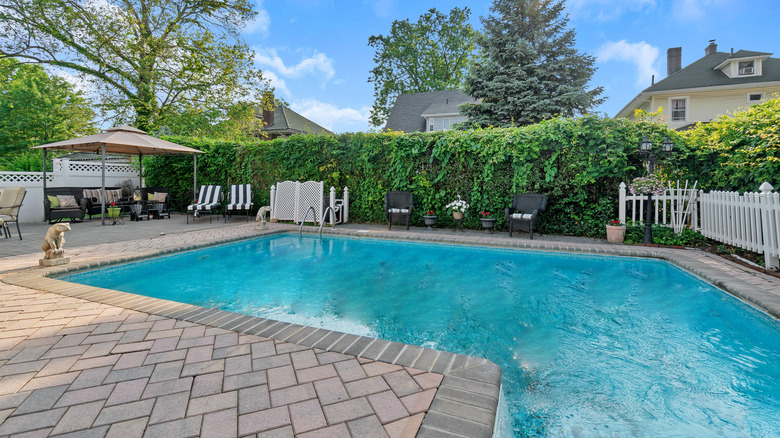 The pool is surrounded by pavers.