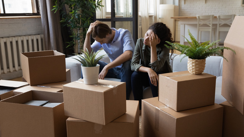 upset couple surrounded by boxes