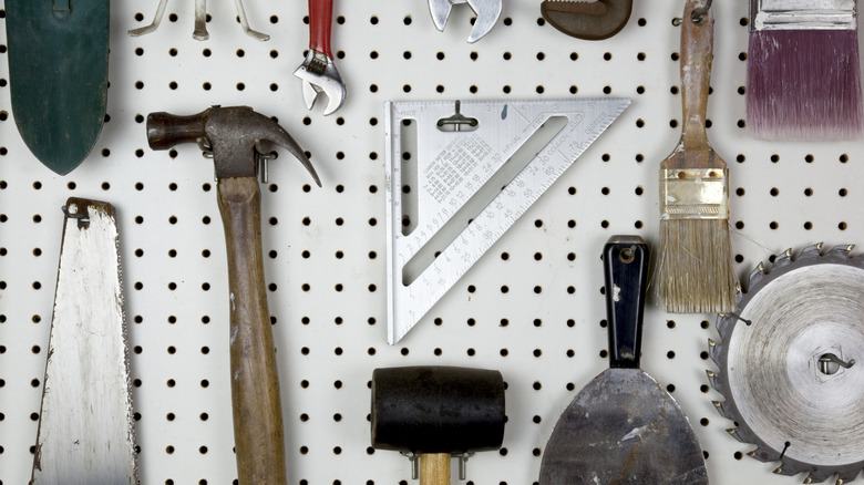 Pegboard holding household tools.