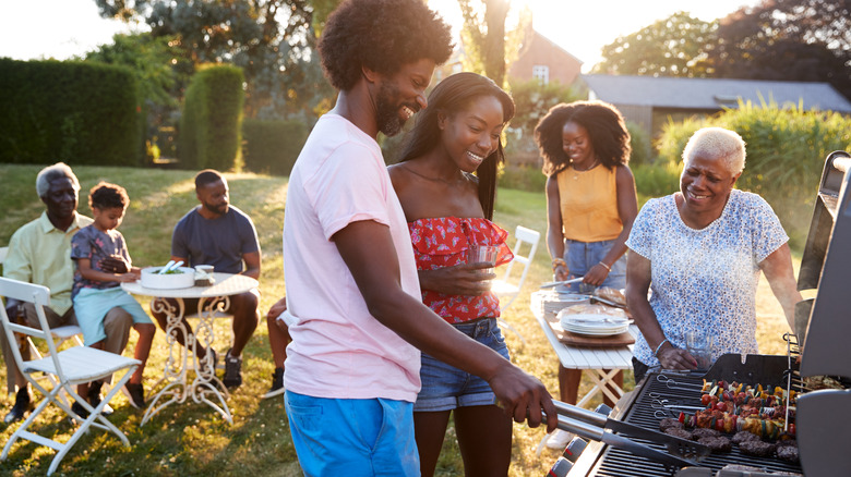 Family barbecuing in backyard 